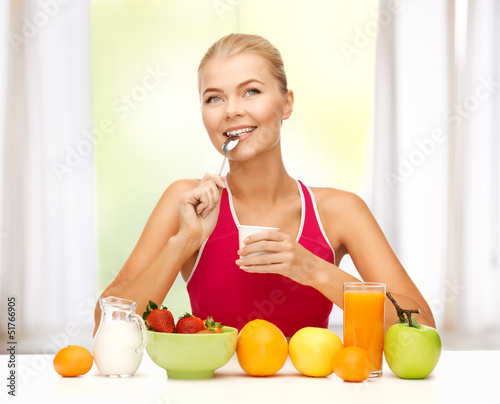 Photo: young woman eating healthy breakfast young woman eating healthy breakfast