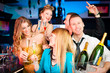 People in club or bar drinking champagne