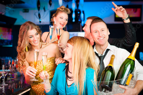 Photo: People in club or bar drinking champagne People in club or bar drinking champagne
