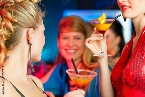 Photo: People in club or bar drinking cocktails People in club or bar drinking cocktails