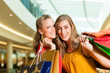 Foto: Two women shopping with bags in mall Two women shopping with bags in mall