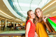 Foto: Two women shopping with bags in mall Two women shopping with bags in mall
