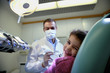 young girl lying on couch in dentist studio looking at camera