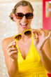 Young woman at optician with sunglasses