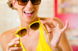 Photo: Young woman at optician with sunglasses Young woman at optician with sunglasses