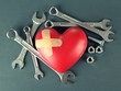 Heart and tools. Concept: Renovation of heart. On color