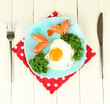 Sausages in form of hearts, scrambled eggs and parsley,