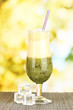 Delicious fruit smoothie on bright background