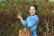 Photo: woman aged near rose bush woman aged near rose bush
