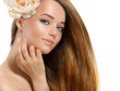 Beauty Girl. Beautiful Model with Rose Flower Touching her Face