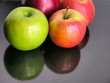 Photo: red and green apples on black table red and green apples on black table