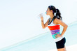 Sports woman drinking water