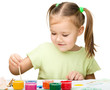 Cute cheerful child play with paints