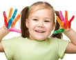 Portrait of a cute girl playing with paints