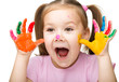 Portrait of a cute girl playing with paints