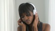 Black woman listening to music and dancing