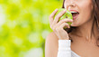 Photo: Woman in fitness wear with apple, outdoors Woman in fitness wear with apple, outdoors