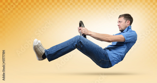 Photo: Man car driver with a wheel, yellow taxi concept Man car driver with a wheel, yellow taxi concept