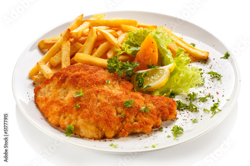 Photo: Pork chop, French fries and vegetables Pork chop, French fries and vegetables