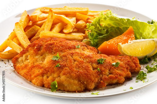 Photo: Pork chop, French fries and vegetables Pork chop, French fries and vegetables