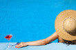 Woman at poolside with cosmopolitan cocktail