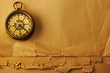Antique brass compass over old background