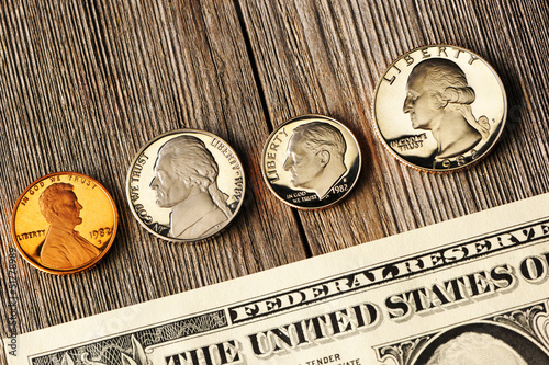 Photo: US money over wooden background US money over wooden background