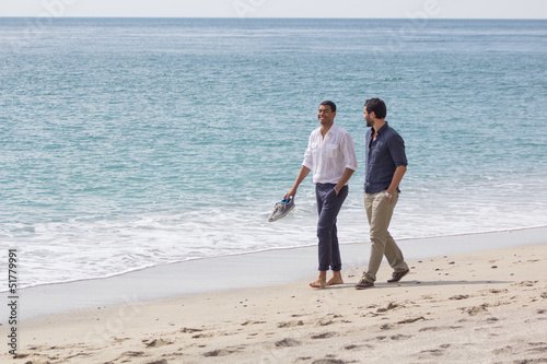 Photo: Couple of handsome friends, walking in a seaside Couple of handsome friends, walking in a seaside