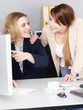 Two business women work togehter in the office