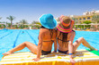 Photo: Relax of two tanned girls at swimming pool Relax of two tanned girls at swimming pool