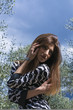 Closeup of young woman in the garden with storm sky