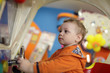 Boy playing with amusement machine