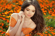 Young woman outdoors portrait over orange marigold flowers