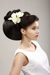 Charisma. Woman with Futuristic Hairstyle and Orchid Flowers