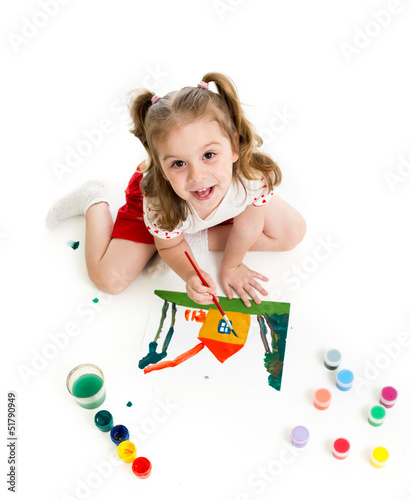 Photo: Kid girl is painting. Top view. Kid girl is painting. Top view.