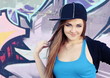 Smiling Teenager Girl Posing near Wall