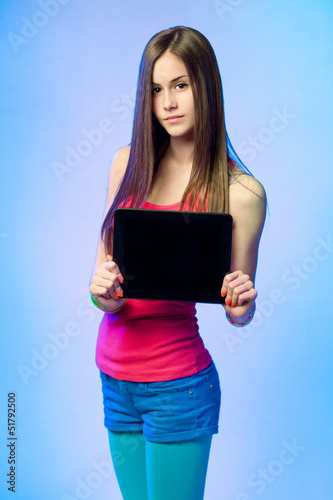Photo: Teen cutie with tablet for copy space. Teen cutie with tablet for copy space.