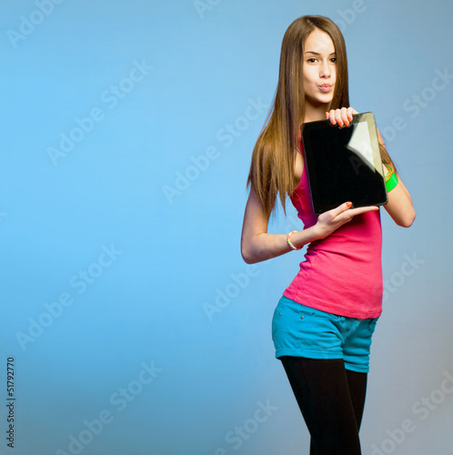 Photo: Teen cutie with tablet for copy space. Teen cutie with tablet for copy space.