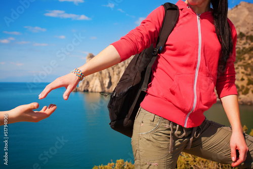 Photo: helping hand stretched out to a friend in a campaign helping hand stretched out to a friend in a campaign