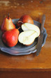 Fresh ripe pears in a plate with napkin and knife