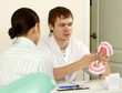 Portrait of handsome young dentist teaching