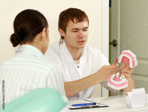Photo: Portrait of handsome young dentist teaching Portrait of handsome young dentist teaching