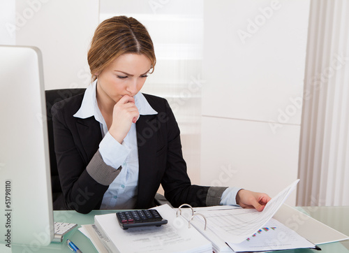 Photo: Businesswoman Working In Office Businesswoman Working In Office