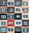 Collage of weathered house numbers on the wall