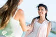 Women handshaking outdoors