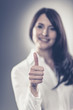 Photo: Woman making a thumbs up sign Woman making a thumbs up sign
