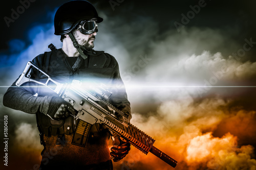 Photo: assault soldier with rifle on apocalyptic clouds assault soldier with rifle on apocalyptic clouds