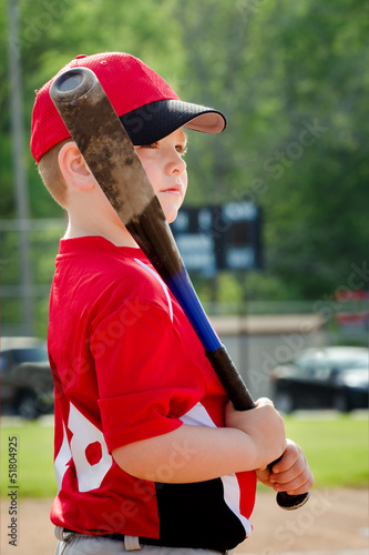 Photo: Portrait of child preparing to bat during baseball game Portrait of child preparing to bat during baseball game