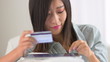 Chinese woman making a purchase on a tablet