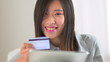 Chinese woman making a purchase on a tablet